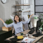 Happy businesswoman in office. Businesswoman celebrating a big accomplishment at work