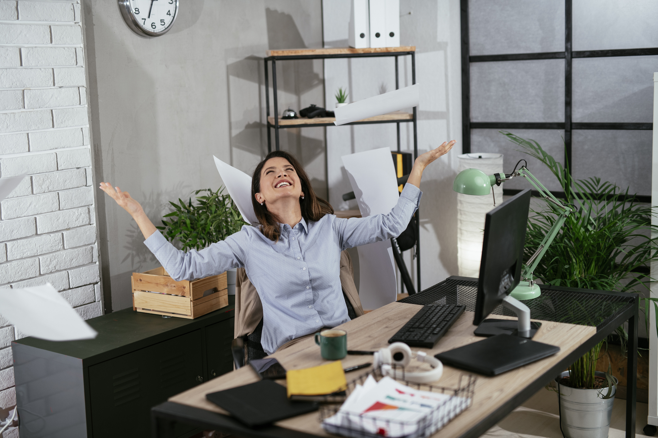 Happy businesswoman in office. Businesswoman celebrating a big accomplishment at work