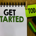 Text sign showing Get Started. Conceptual photo asking someone to begin task endeavour or process right now Notebook clothespin holding reminder markers expressing ideas wood table