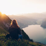 She looks off to the distant European Alps over lake Lugano